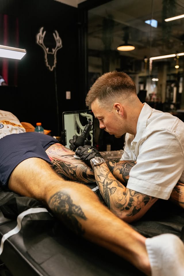 Trevor McQuade tattooing at Ethos Art Collective